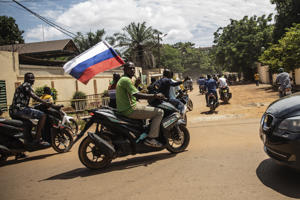 Supporters of captain Ibrahim Traore wave the Russian flag in the streets of Ouagadougou, Burkina Faso, October 2.