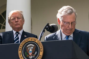 Then-Senate Majority Leader Mitch McConnell (Republican of Kentucky) stands behind President Donald Trump at an event in the Rose Garden of the White House in 2017.