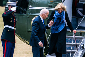President Biden helps First Lady Jill Biden get out of Sea One on the South Lawn of the White House on Monday.