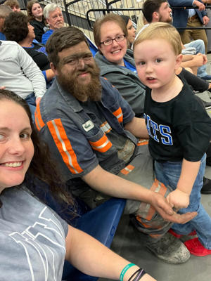 Molly McGuire (left), Michael McGuire and their son Easton during the Blue and White Blast