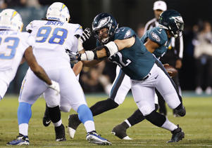 Eagles center Jason Kelsey shoves Los Angeles Chargers linebacker Linval Joseph, Sunday, Nov. 7, 2021, in Philadelphia.