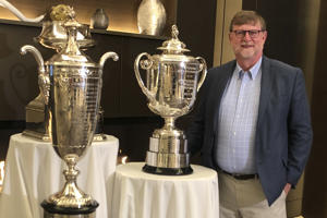 Beau Welling poses with the PGA of America Championship trophies before a preview event for the new PGA facility on Oct. 18, 2019 in Frisco, Texas in this Grace Wine photo. Welling is the golf course architect responsible for PGA Frisco's Fields Ranch West Course. Like many late-game Americans, Bo Welling became addicted to rolling after watching the Olympics on TV and hearing the screams, brooms and rocks. (Photo by Beau Welling Design via AP)
