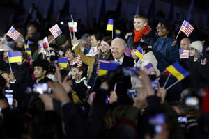 President Biden poses with children after his speech at the Royal Castle in Warsaw on Tuesday.