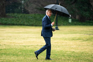 President Biden enters the Oval Office in the rain after a medical examination at the Walter Reed National Military Medical Center.