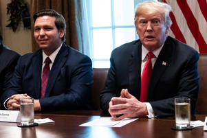 President Donald Trump, seated next to Florida Gov.-elect Ron DeSantis (R), speaks during a meeting with incoming GOP governors at the White House, Dec. 13, 2018.