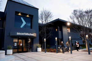 Customers line up outside Silicon Valley Bank headquarters in Santa Clara, California on March 13, 2023.